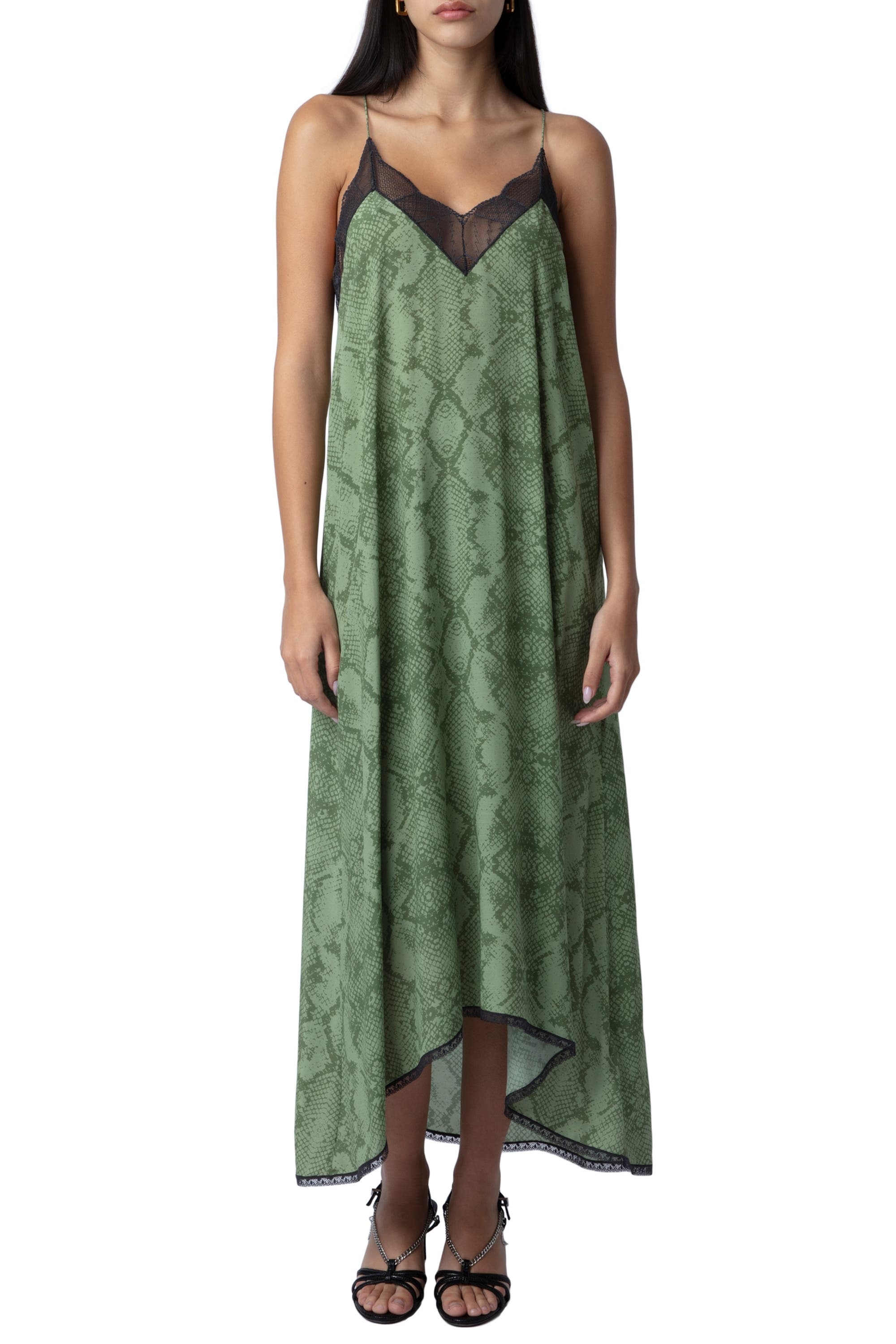 model in green subtle snake print slip maxi dress with black lace trim and a slight high-low hem cut