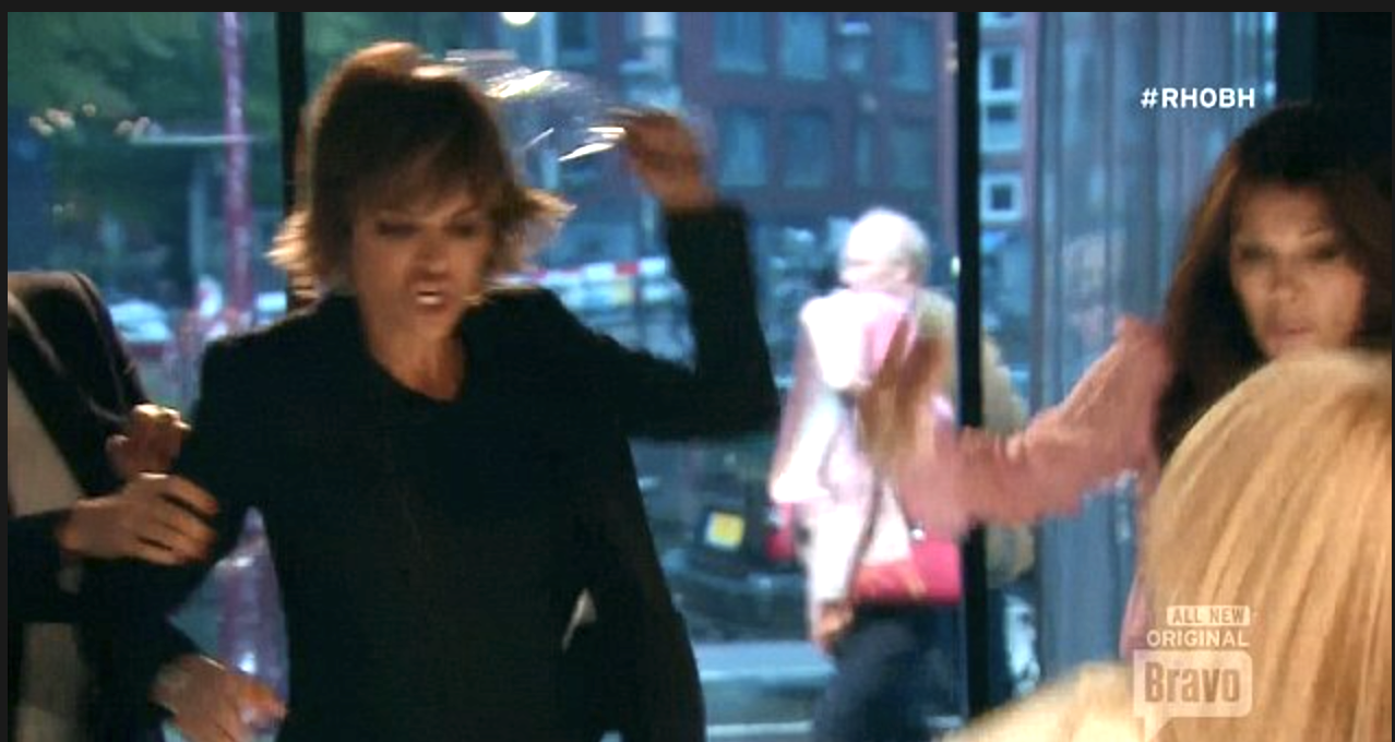 Lisa Rinna slamming a glass onto a table