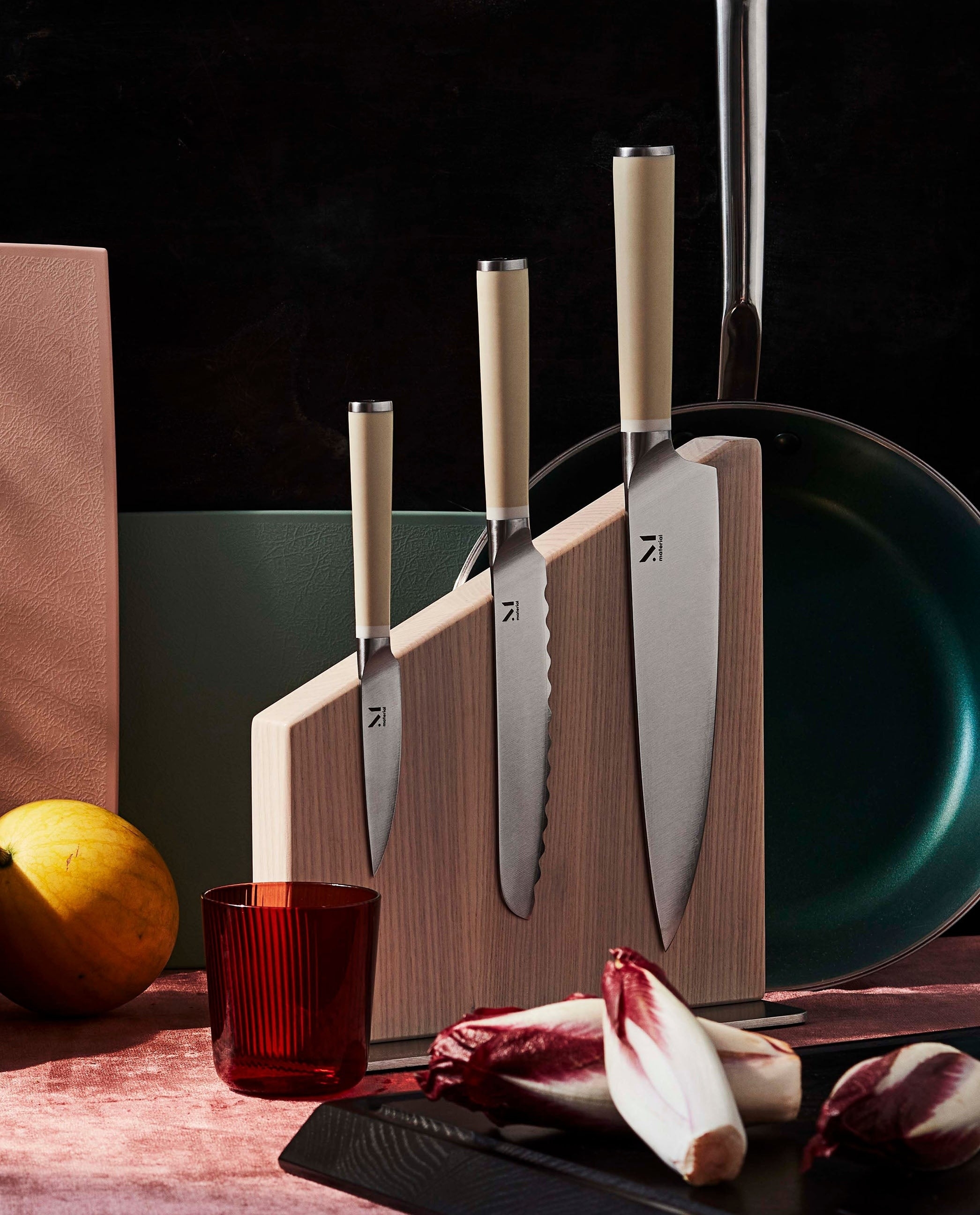 the wooden stand with three kitchen knives
