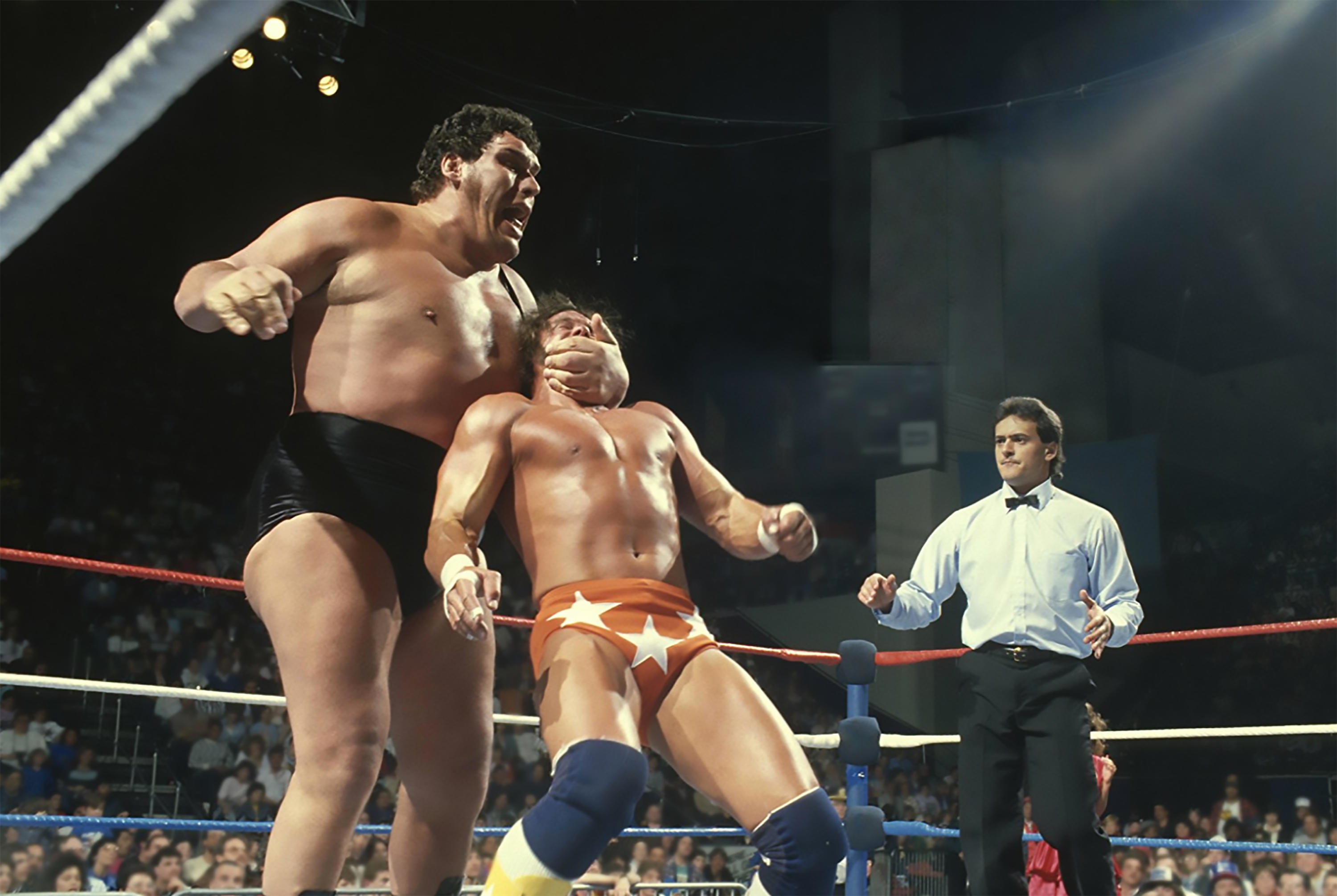 Andre the Giant manhandles &quot;Macho Man&quot; Randy Savage during a wrestling match