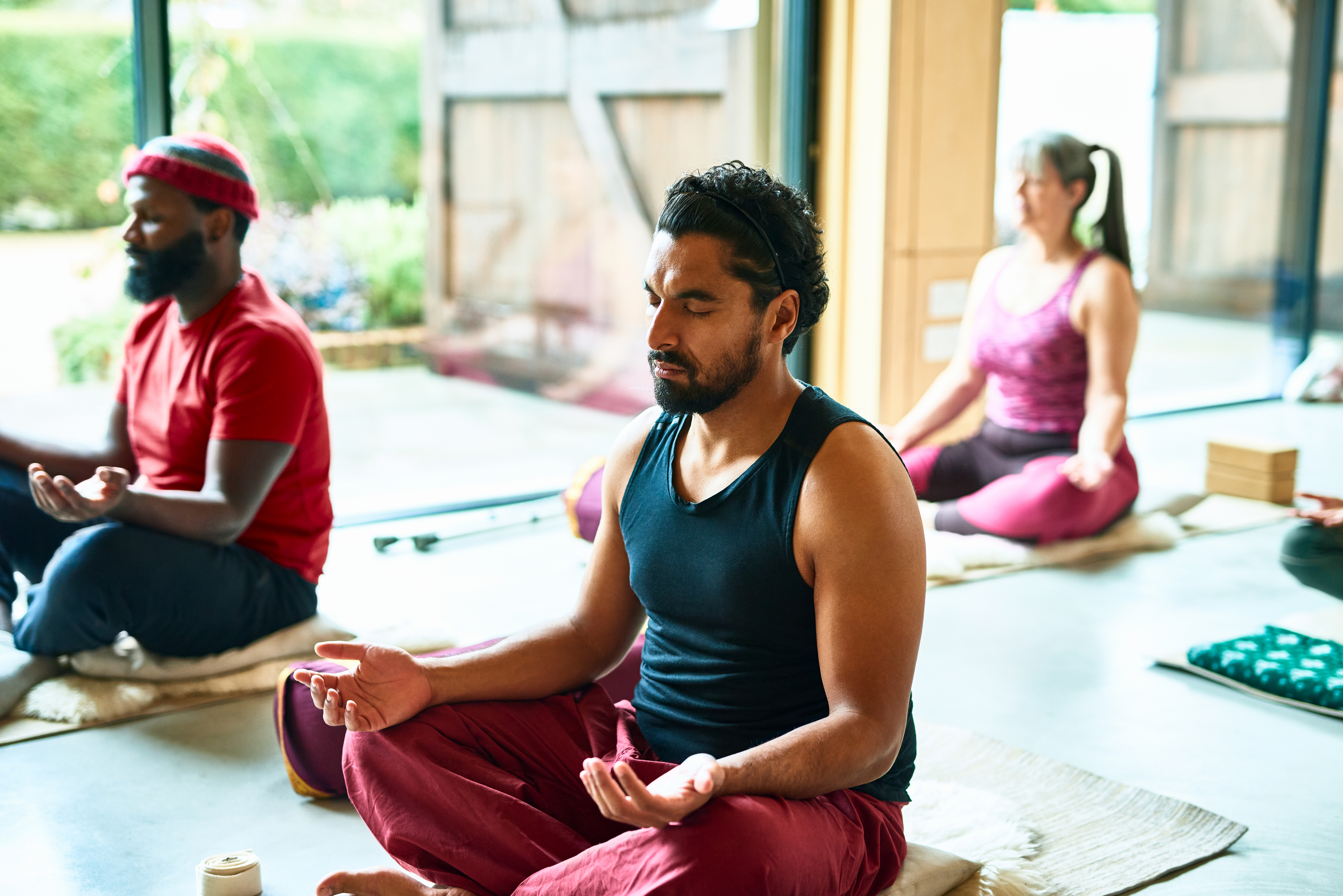 A man meditates in a group class