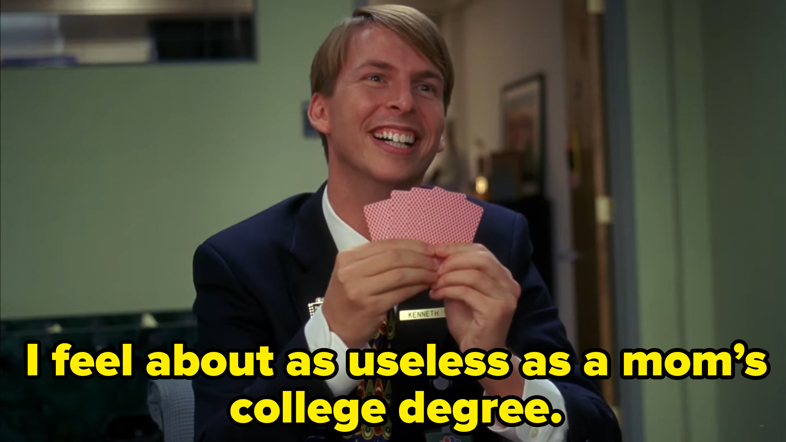 Jack McBrayer talks to someone while holding poker cards