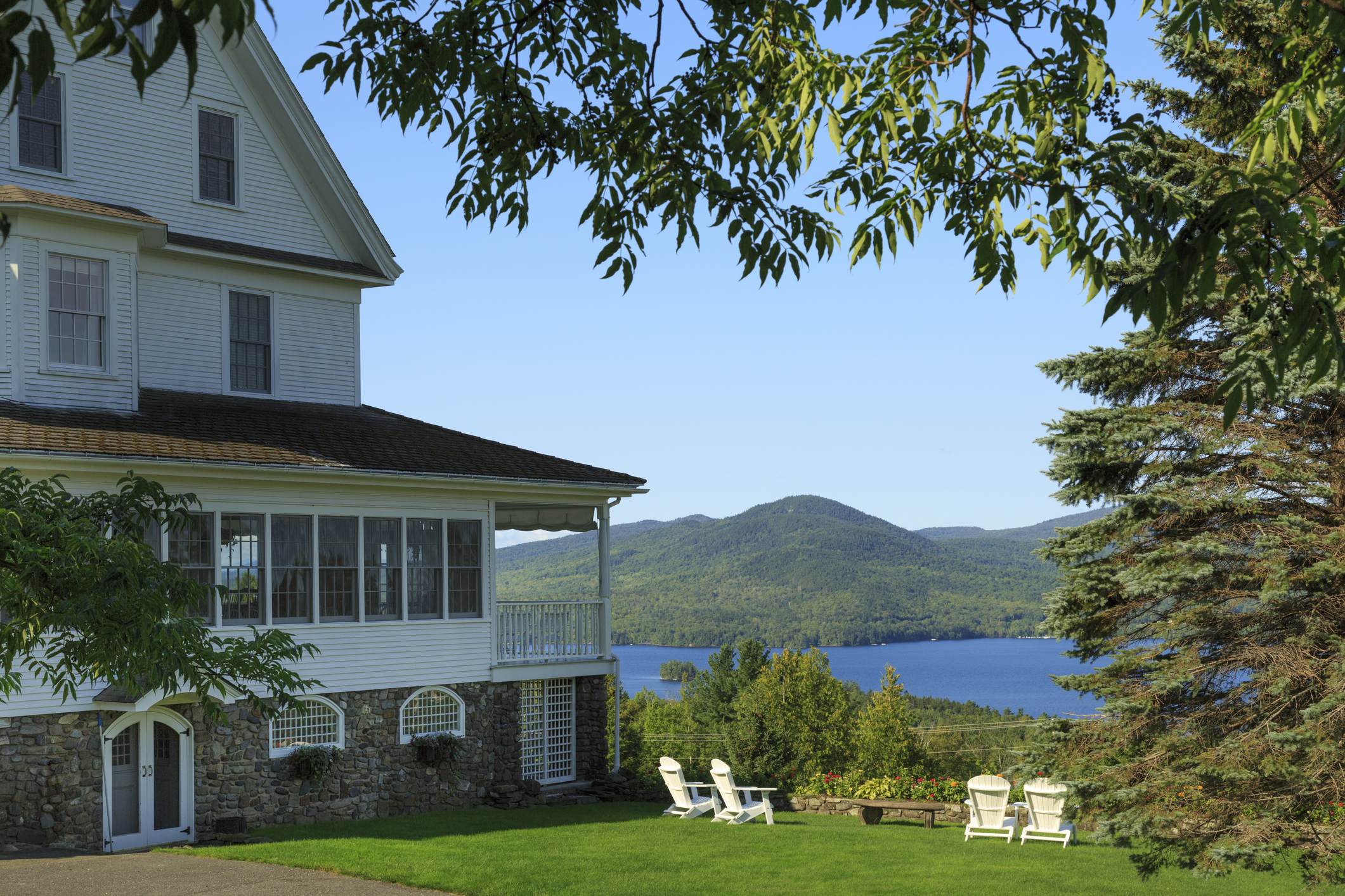 House and Adirondack chairs overlooking Moosehead Lake in Maine