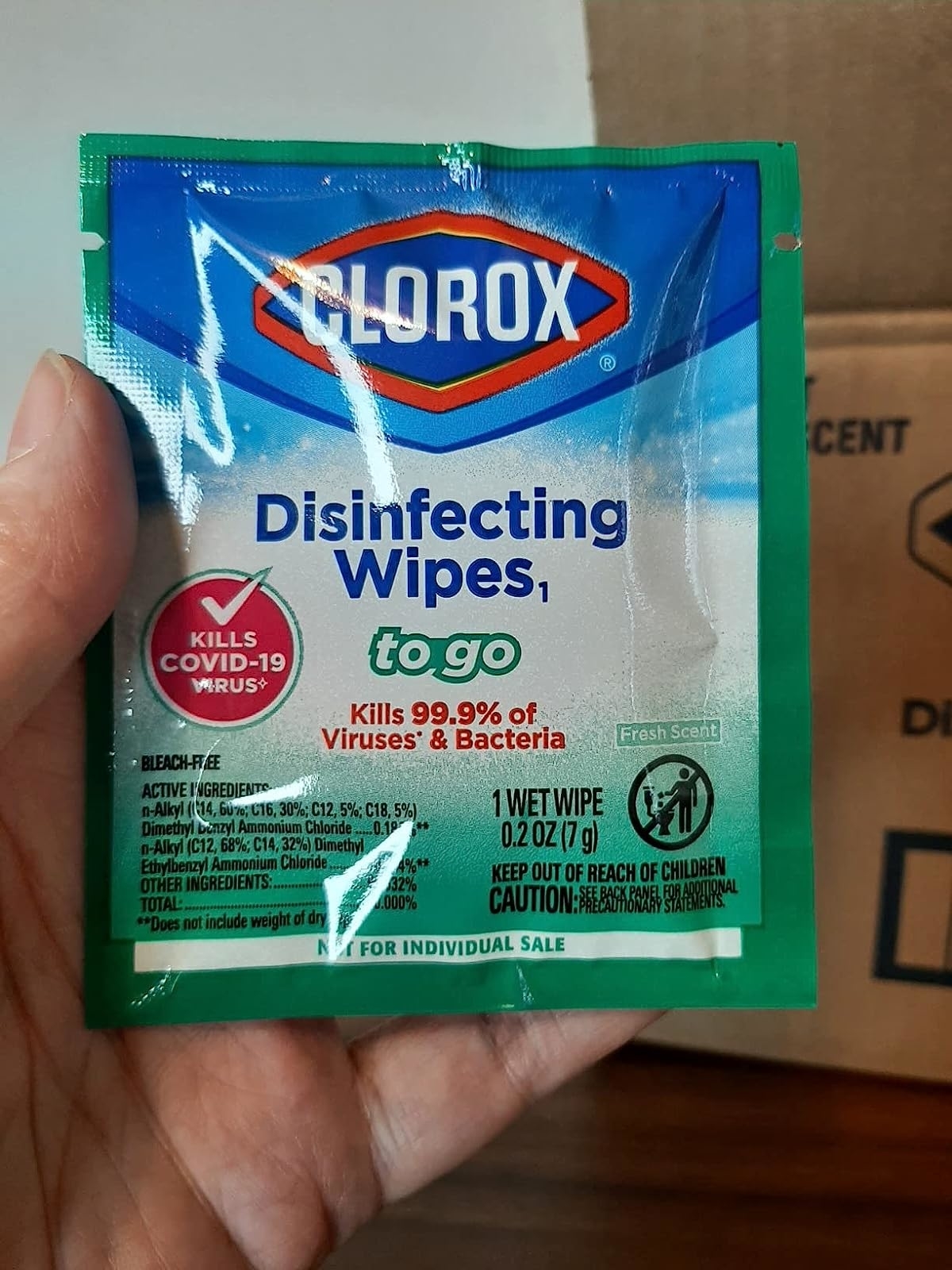 Reviewer&#x27;s photo of their hand holding the wrapped Clorox wipe
