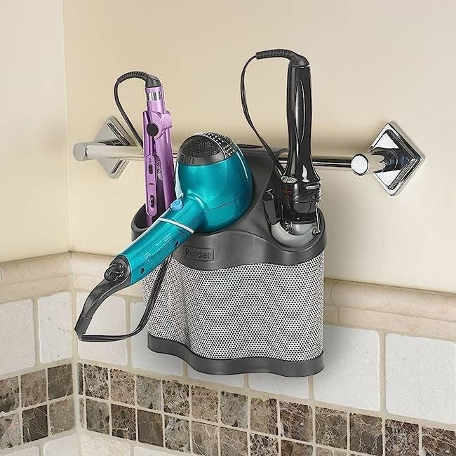 The styling presumption holding hairsbreadth tools and hanging from a towel rack