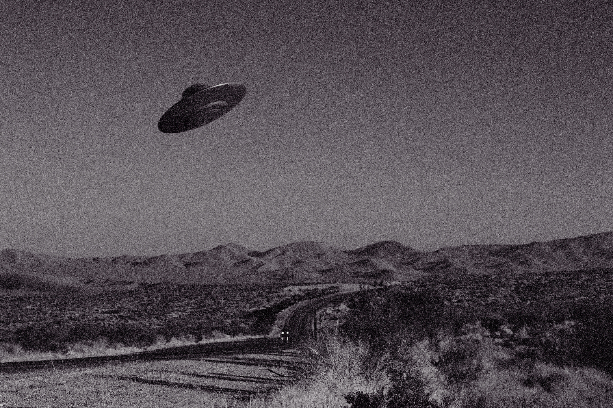 A flying saucer above an arid landscape