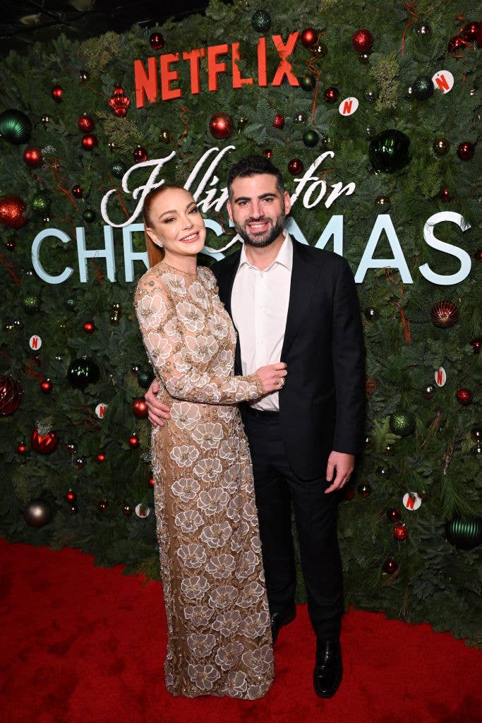 Lindsay Lohan posing with husband Bader Shammas at the Falling For Christmas premiere