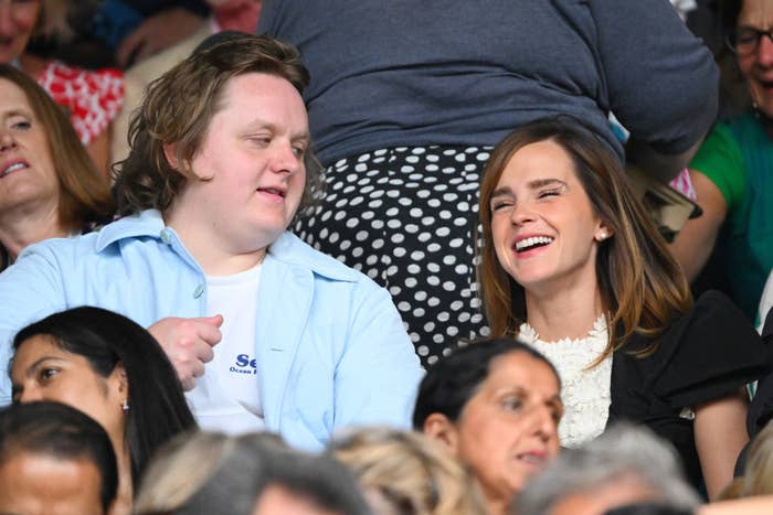 Lewis Capaldi and Emma Watson sat next to each other laughing in the Wimbledon crowd
