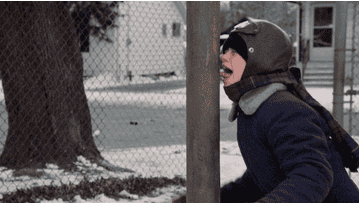 a kid cries with his tongue stuck to a pole in the snow