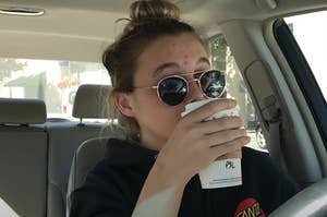 Emma Chamberlain sipping a Starbucks drink in the car