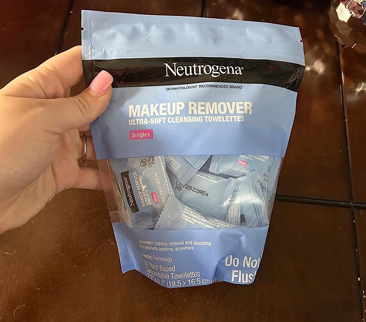 Reviewer holding the pack of make up remover wipes