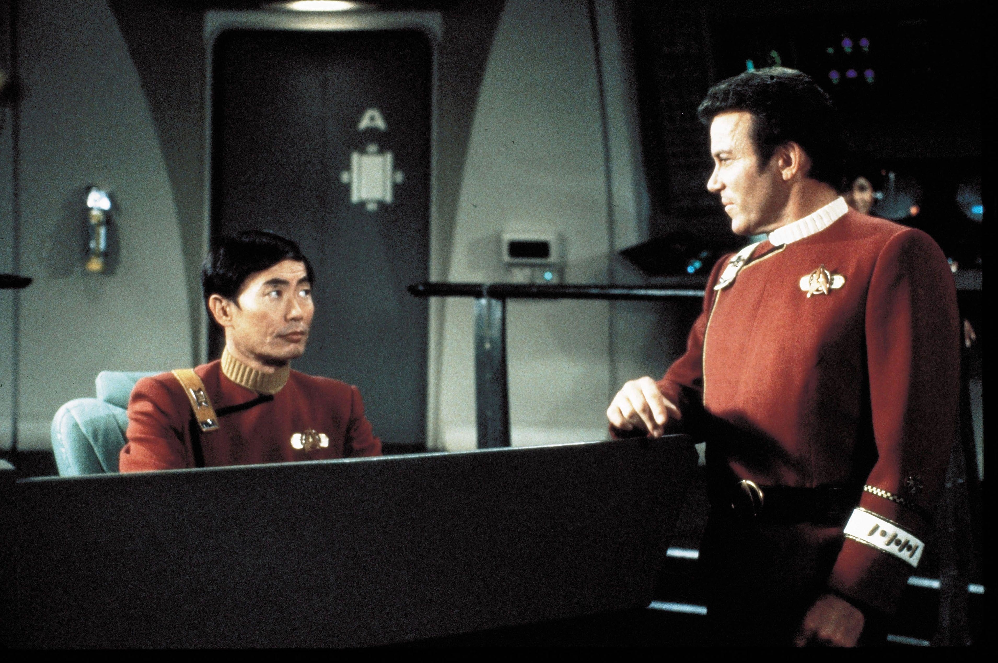 Captain Kirk and Sulu stare at one another aboard the Enterprise