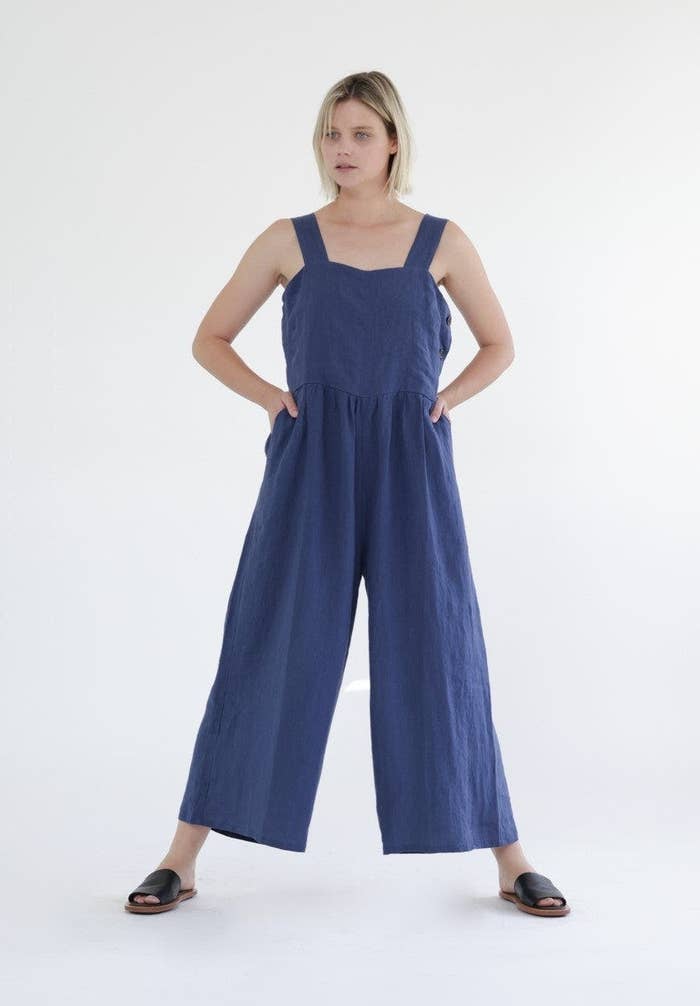 model in navy wide-legged tank jumpsuit with pockets