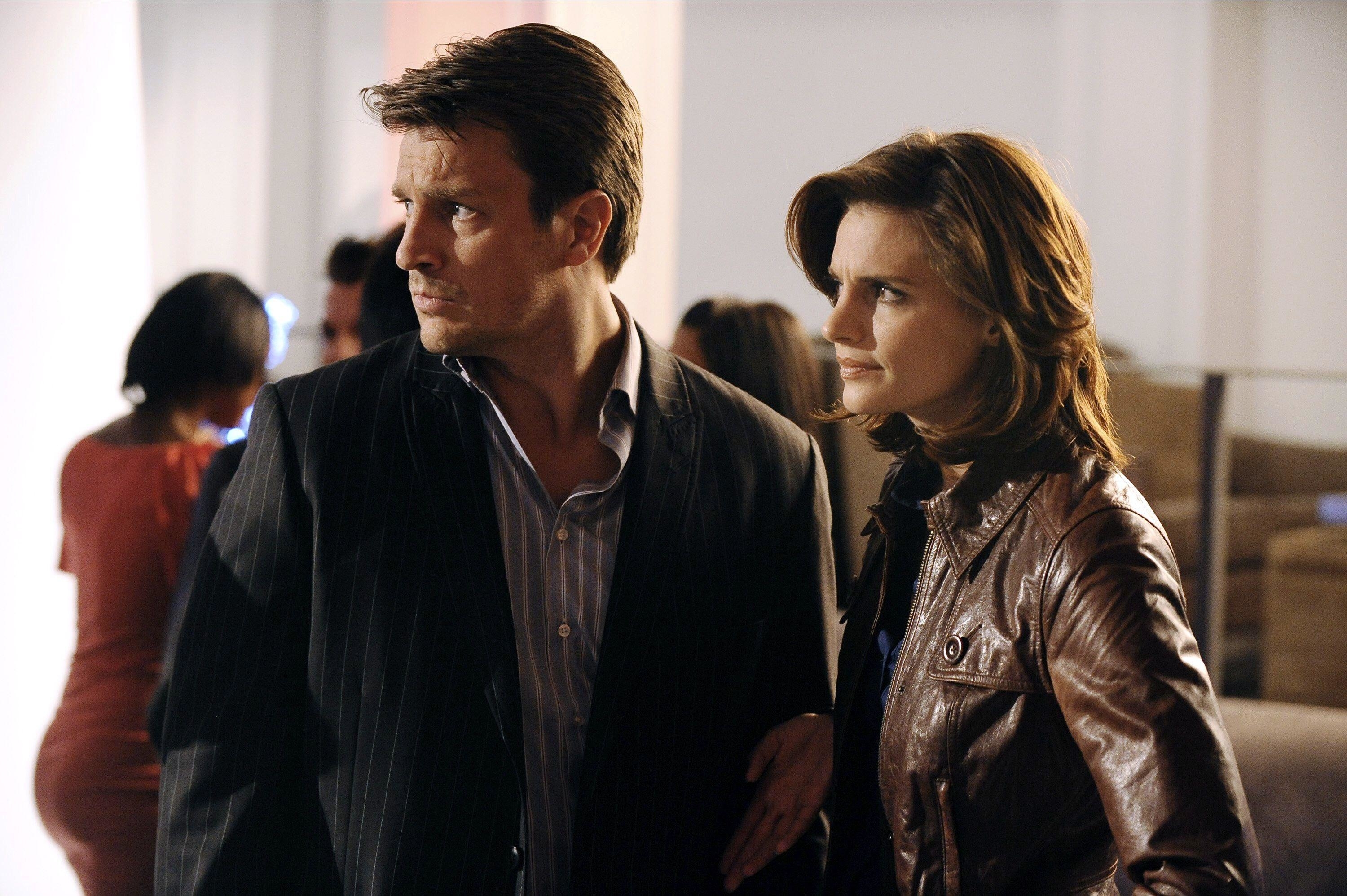 Stana Katic and Nathan Fillion stare off-screen at a crime scene on &quot;Castle&quot;