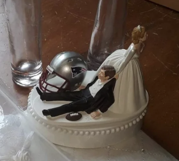 Cake toppers where a bride is pulling the groom against his will