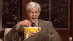 Bill Hader wearing a wig eating popcorn