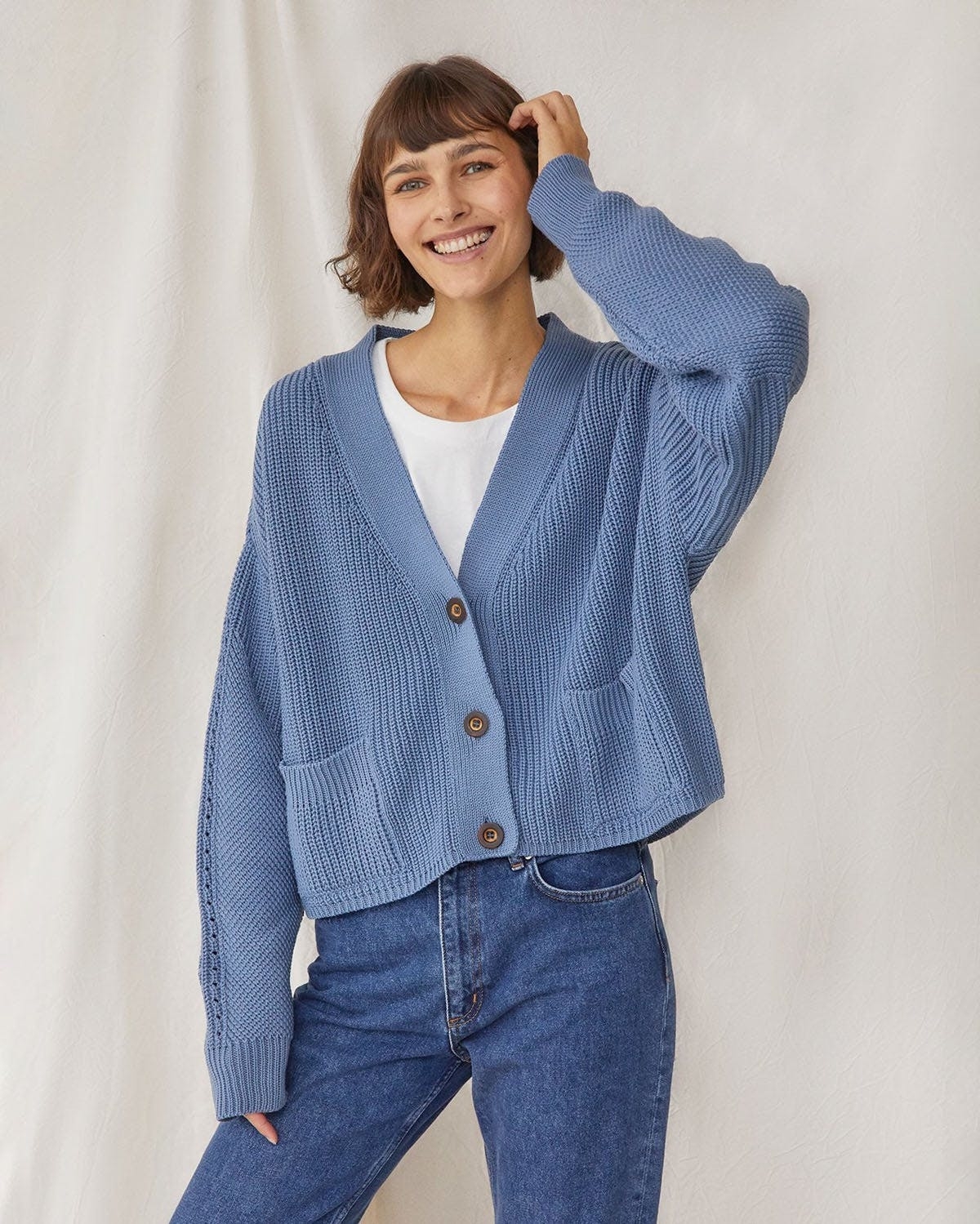 model in light blue boxy cropped ribbed cardigan with buttons