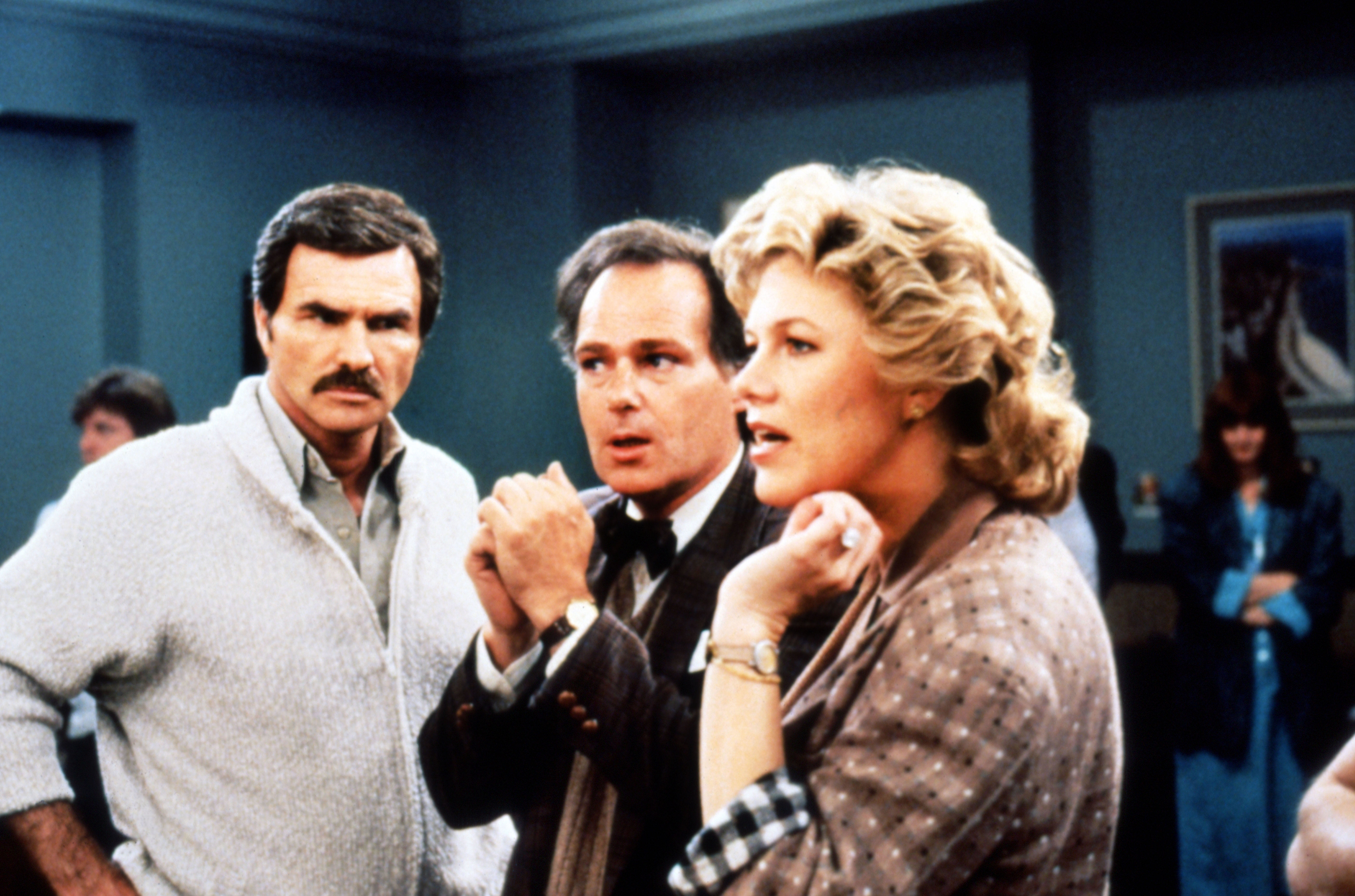 Burt Reynolds looks at Kathleen Turner who&#x27;s standing next to another man in a scene from &quot;Switching Channels&quot;