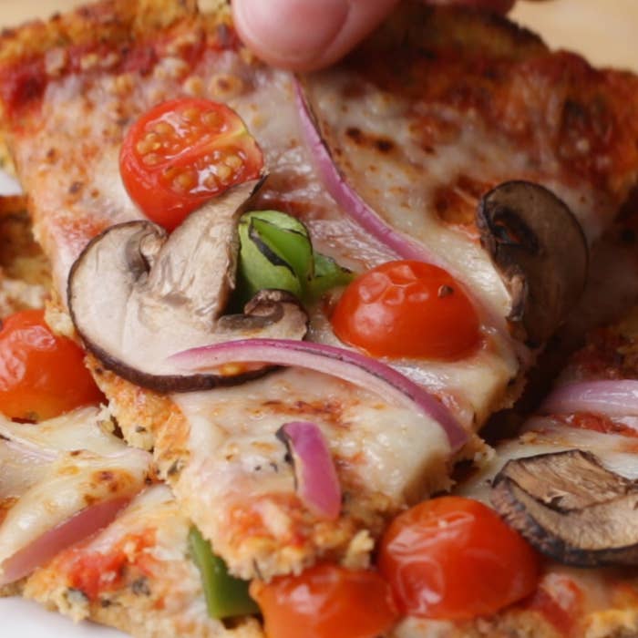 Pizza with mushrooms, tomatoes, and onions