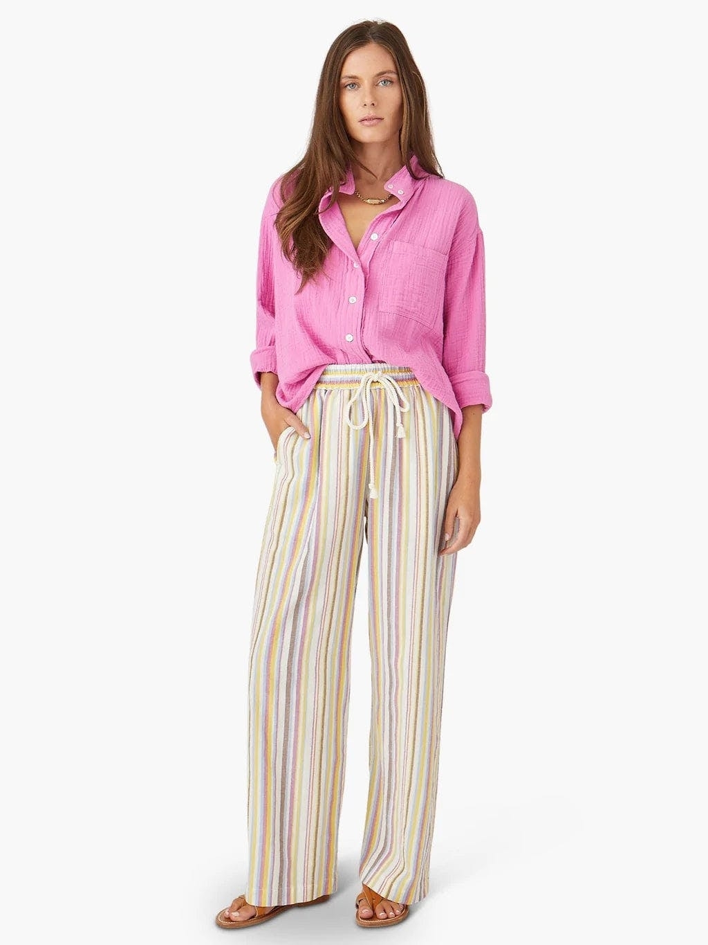 model in straight leg white and pastel color drawstring pants with small vertical stripes