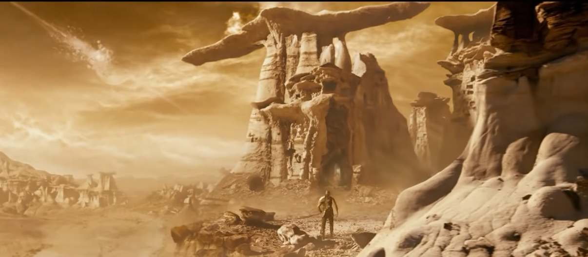 man seen standing in a utopian world that looks like a desert