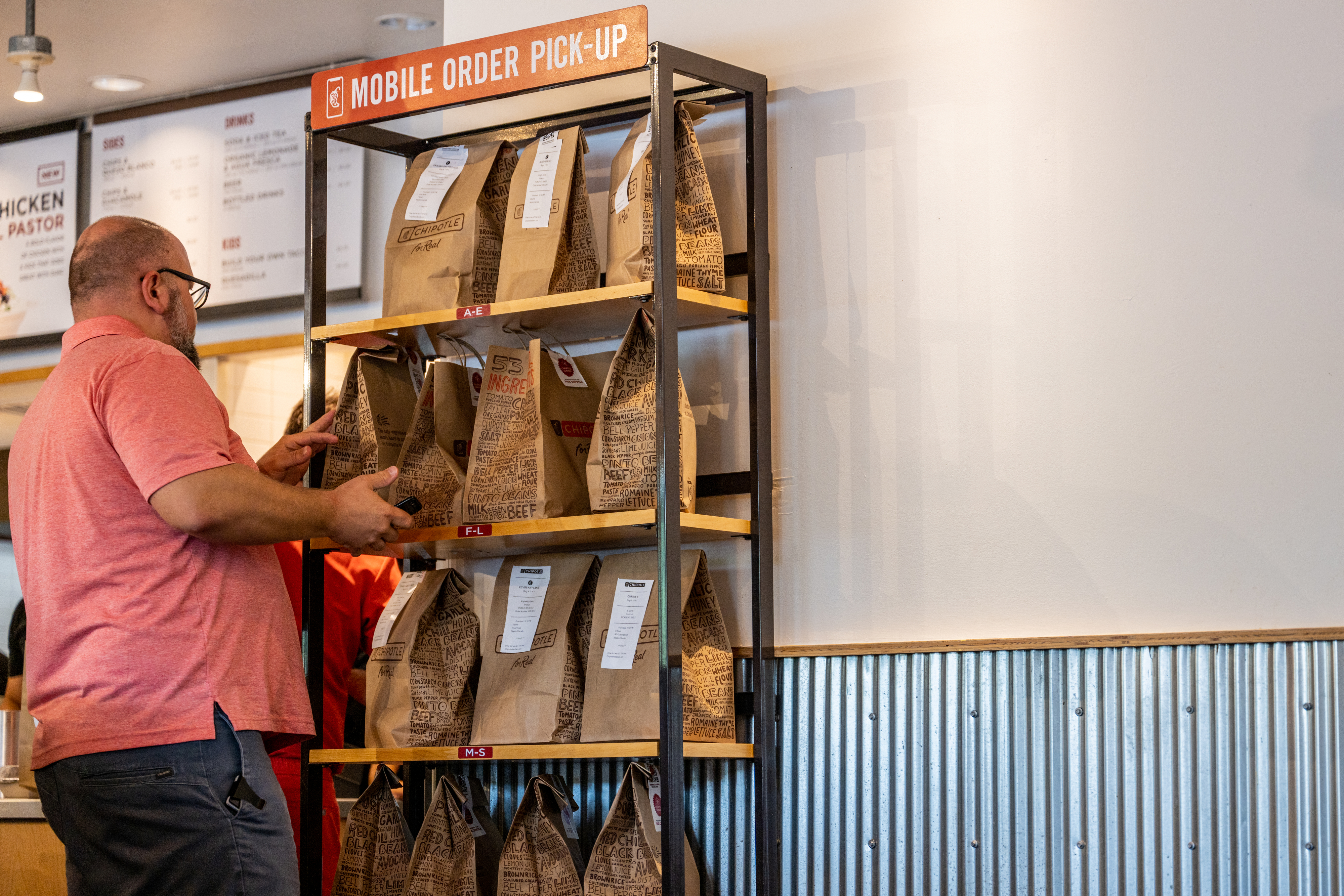 person picking up mobile order at a Chipotle location