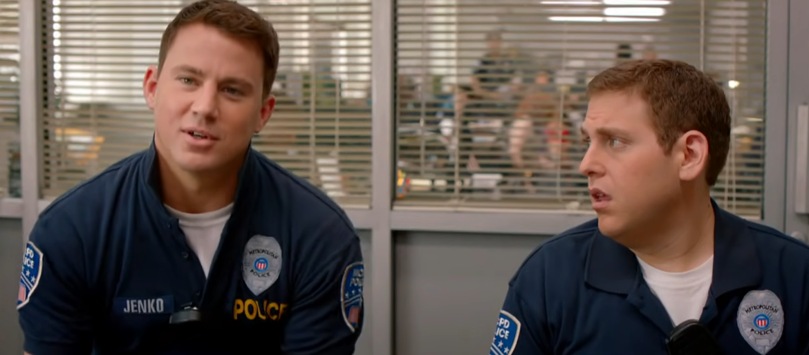 two young cops sitting in an office