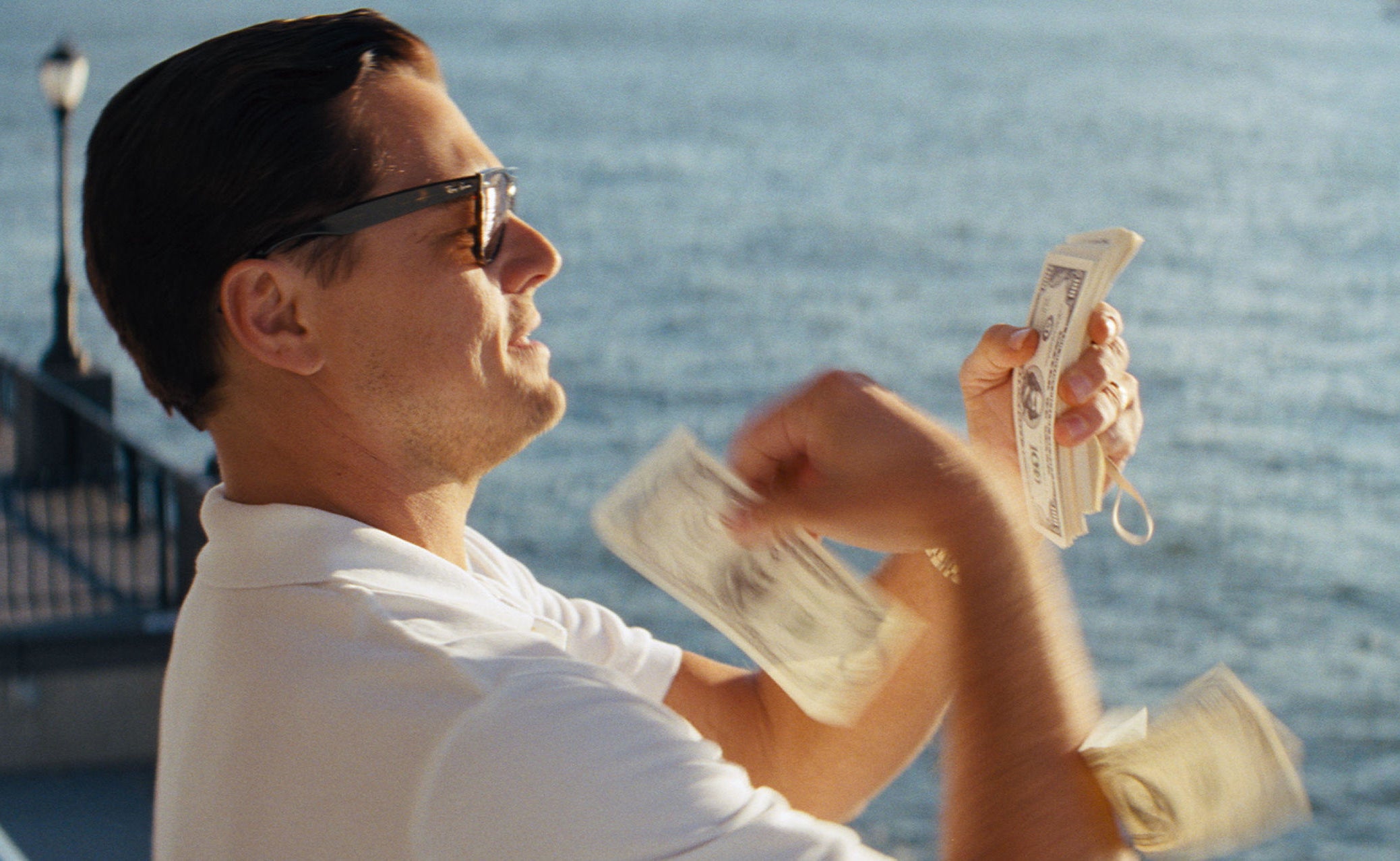 Leonardo DiCaprio throwing money around in The Wolf of Wall Street