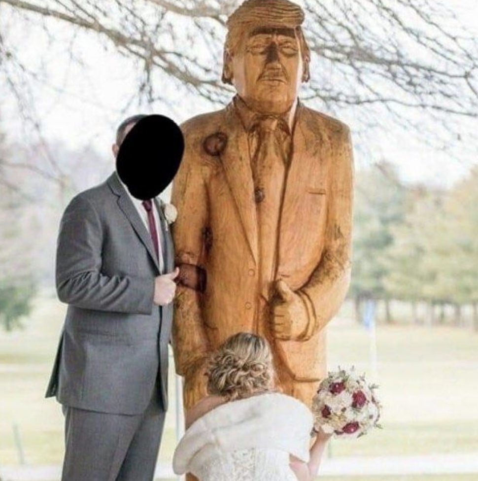 A couple posing suggestively with a Donald Trump wooden statue