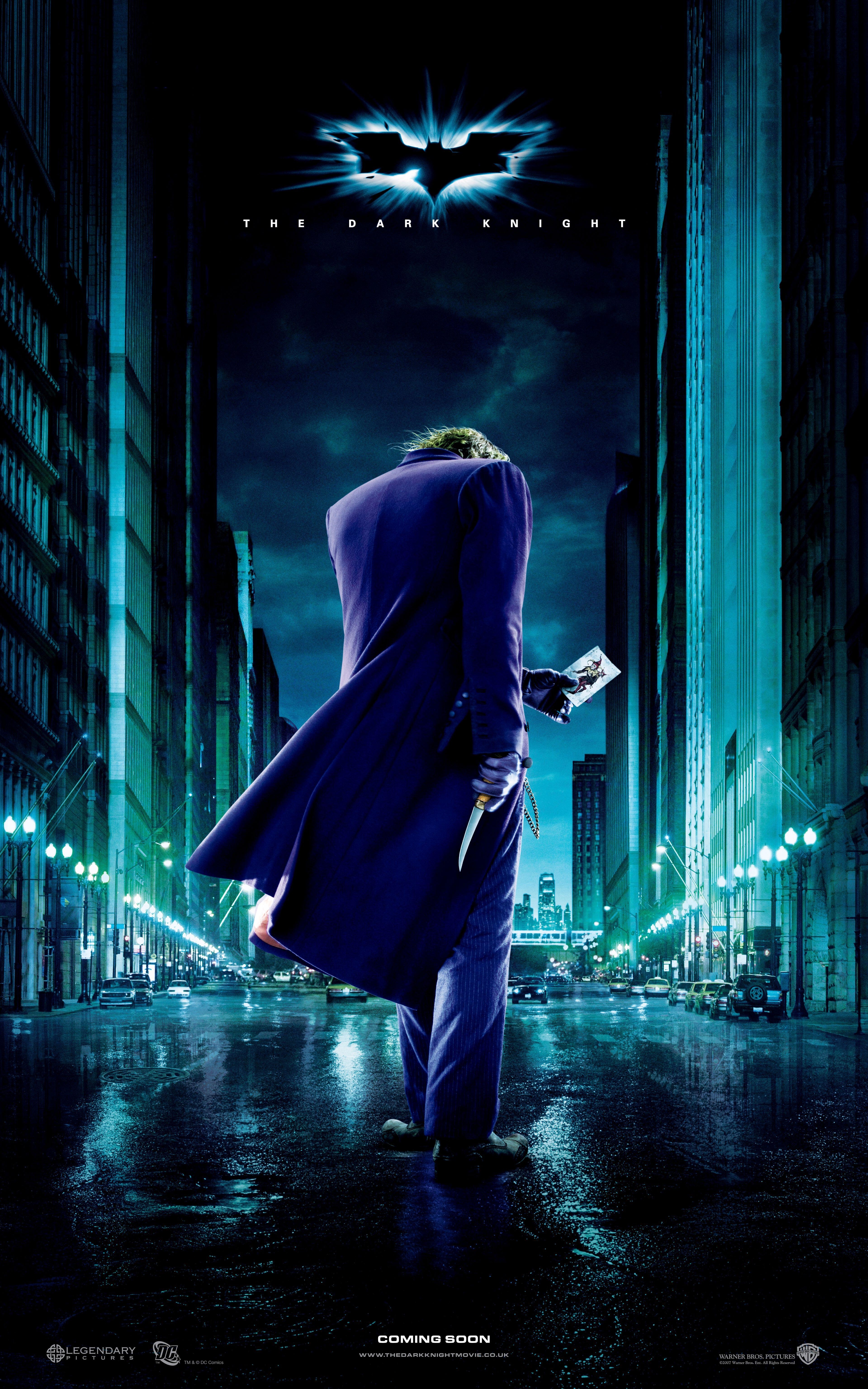 The Joker stands with his back to us on The Dark Knight movie poster.