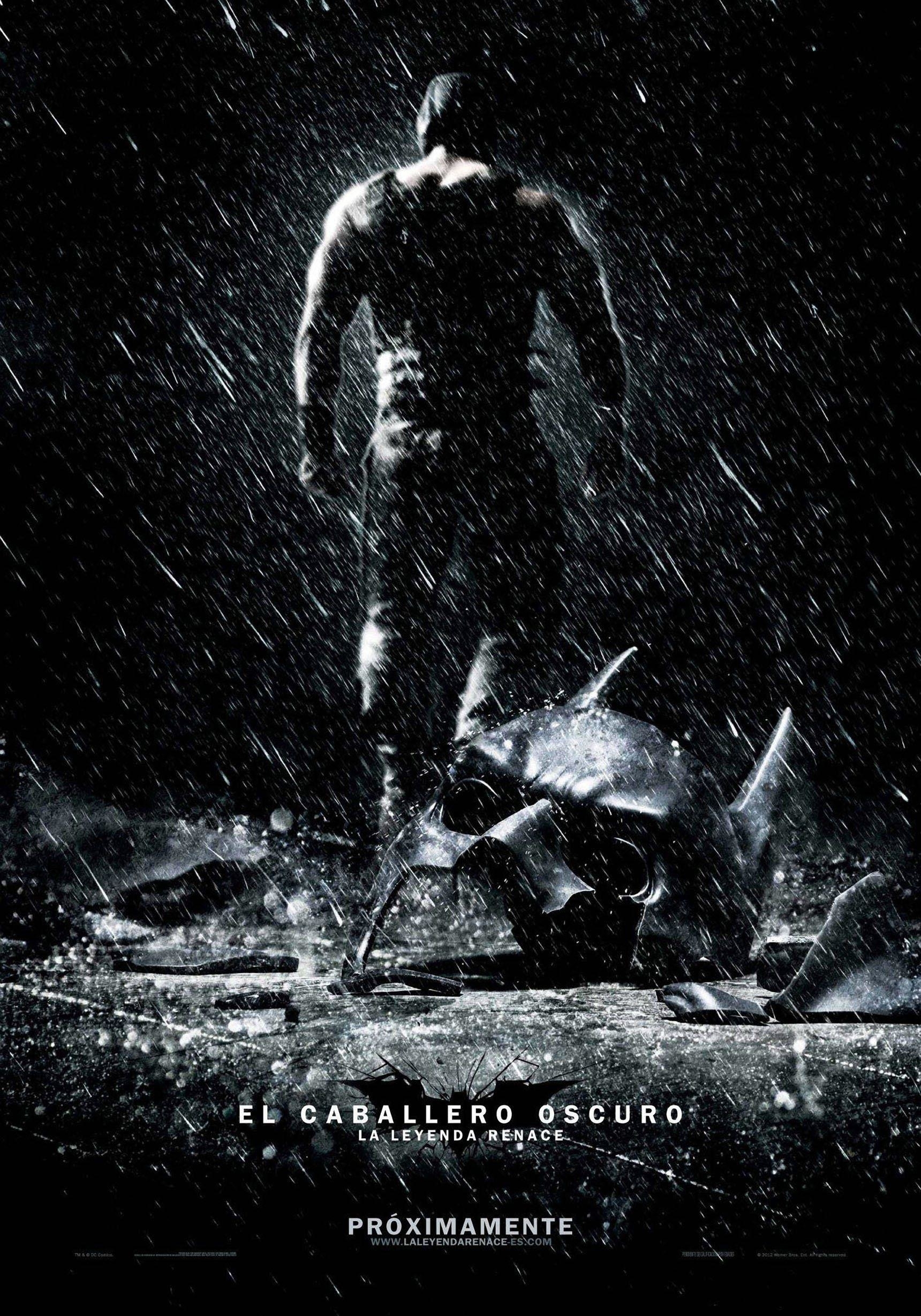 Bane walks away from a broken Batman cowl on The Dark Knight Rises movie poster.