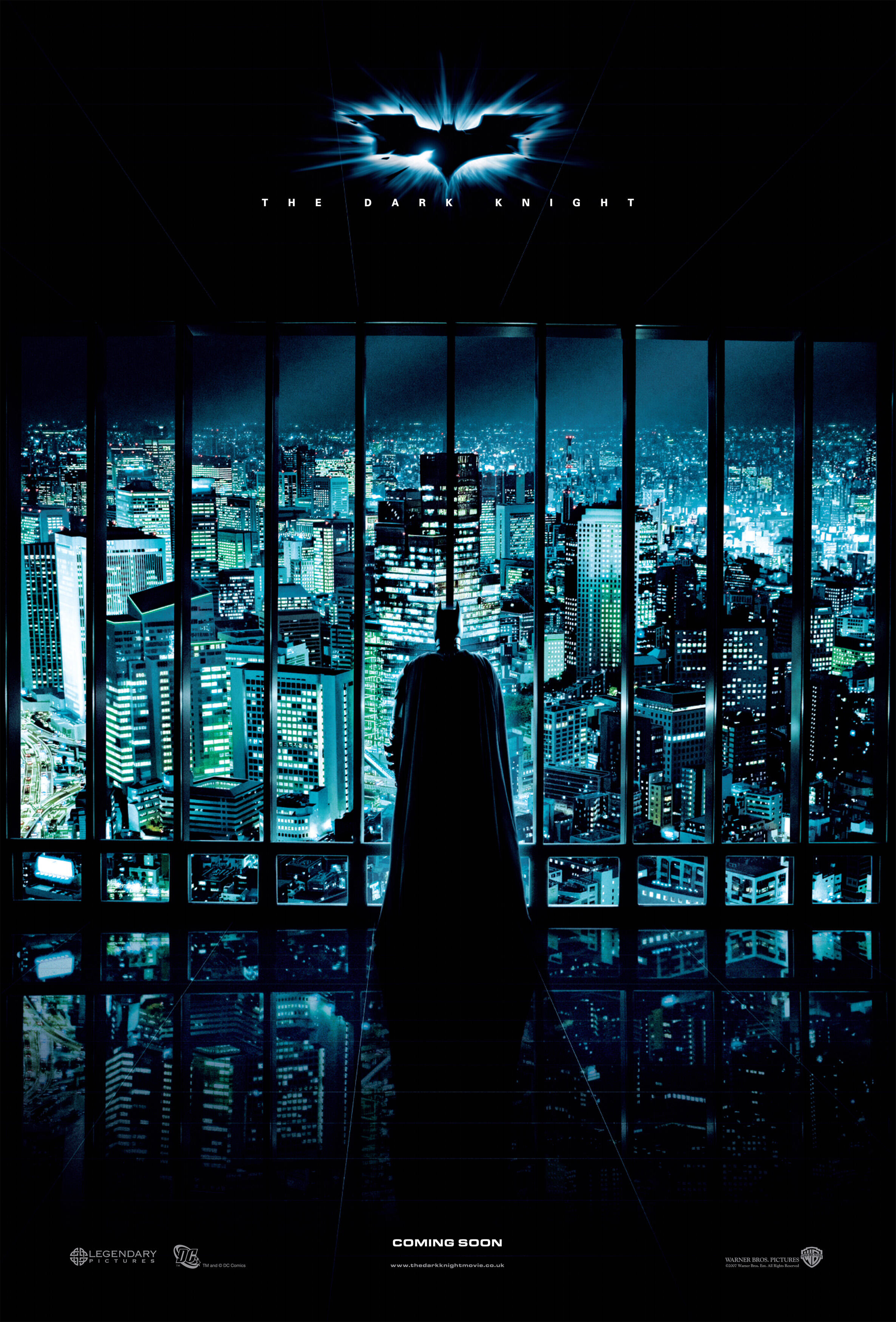 Batman stands staring at the city with his back to us, centered on The Dark Knight teaser movie poster.