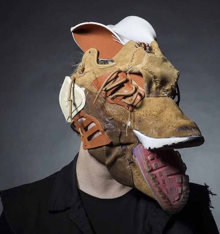 A scary, leathery mask made up of sneaker parts