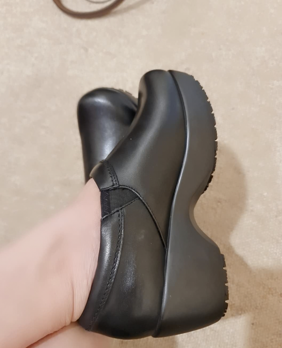 reviewer wearing black clogs