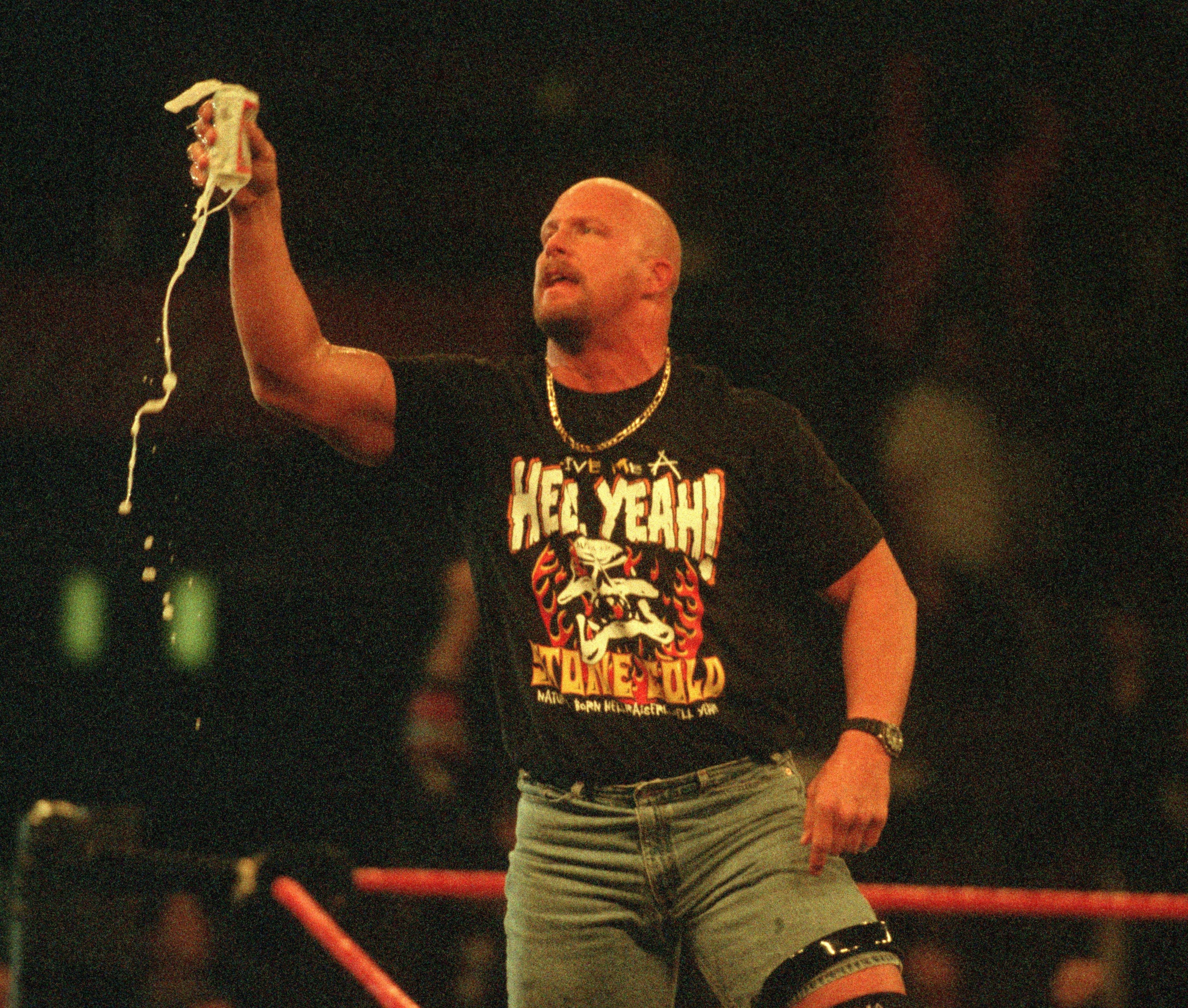 &quot;Stone Cold&quot; Steve Austin raises an overflowing beer to the crowd