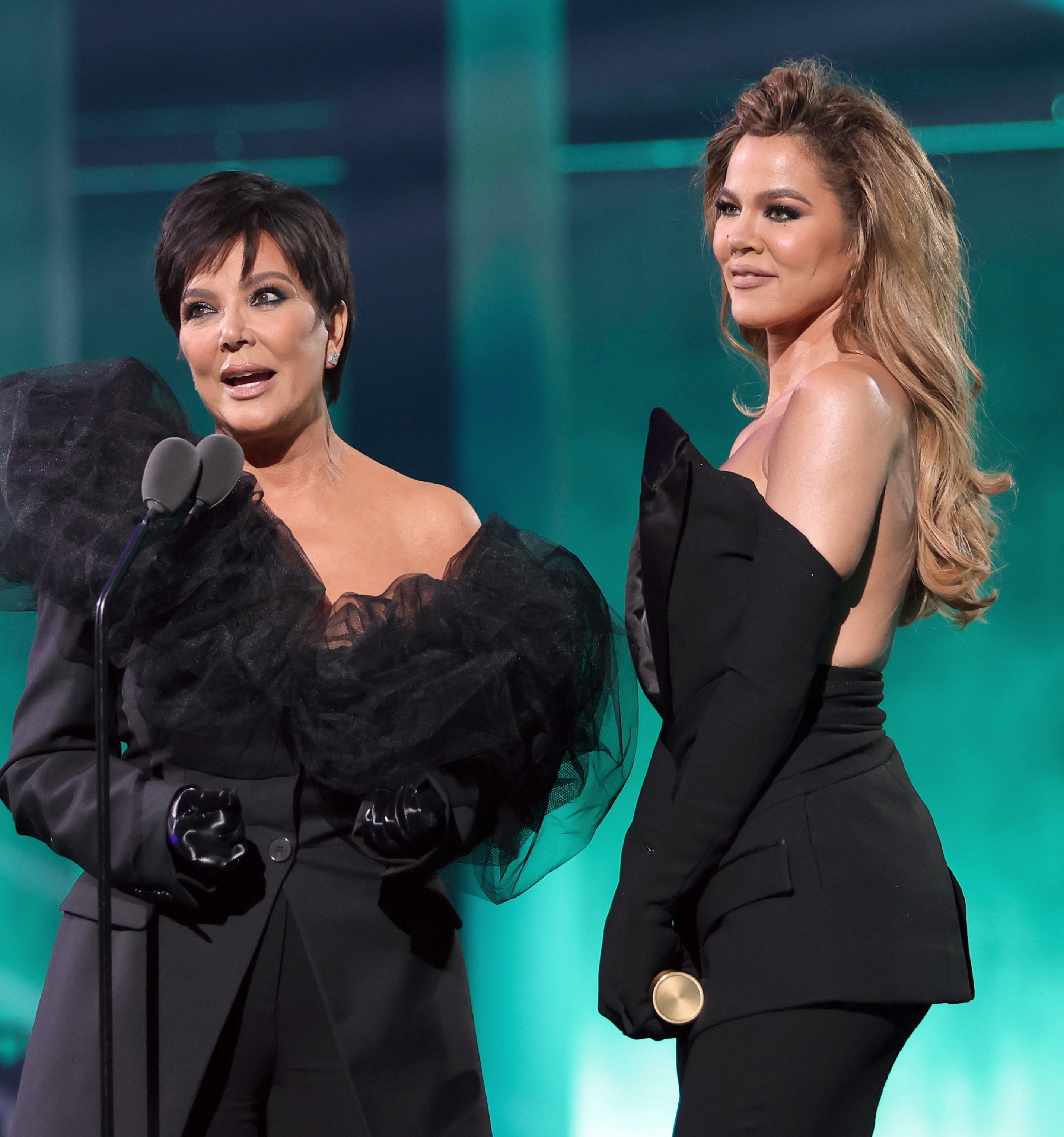 Kris Jenner and Khloé onstage at a microphone