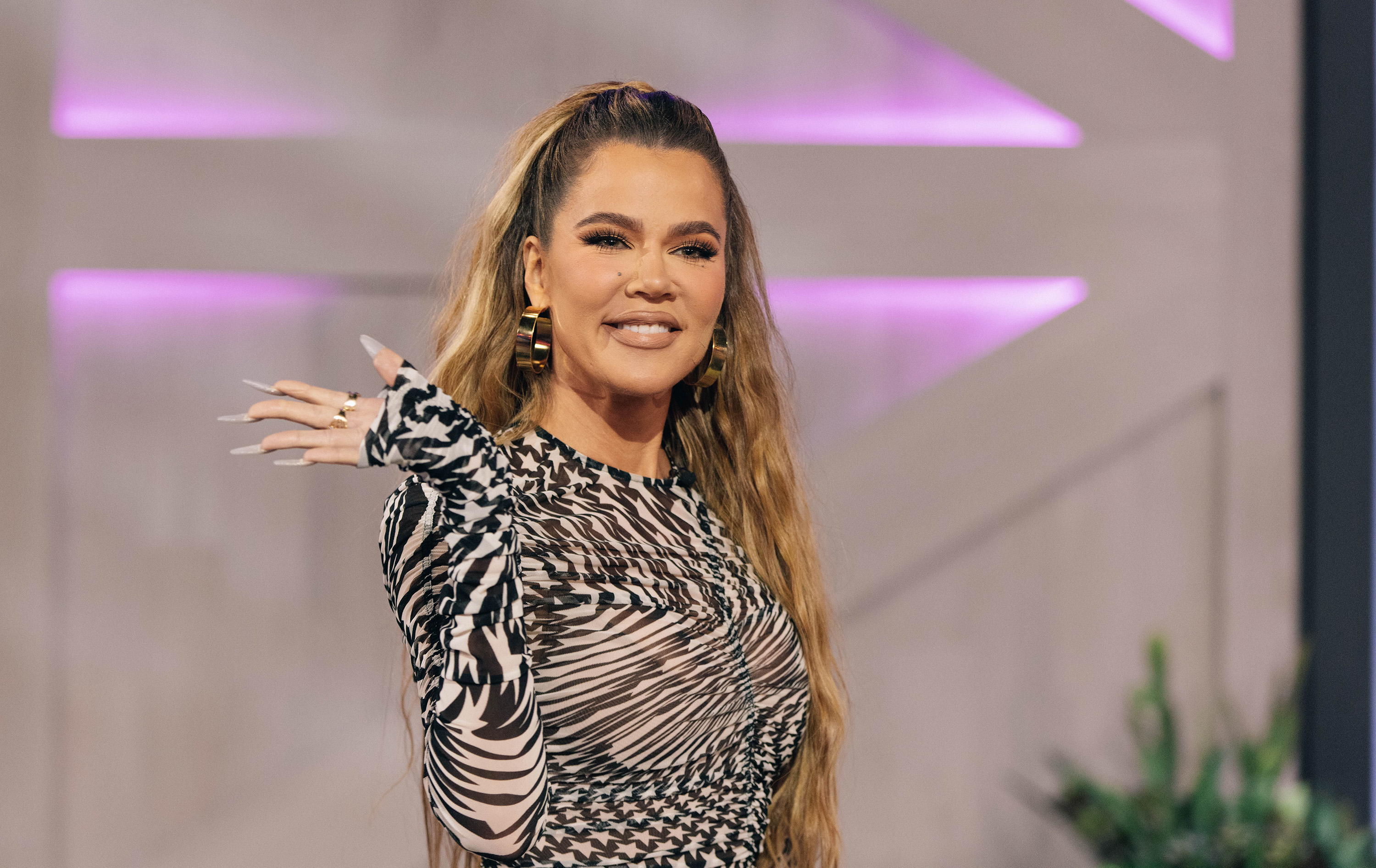 Close-up of Khloé waving