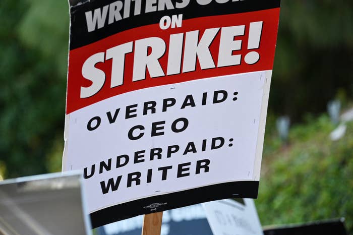 A closeup of a poster that says Strike: Overpaid: CEO: Underpaid Writer