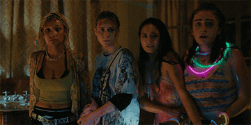 Four young women looking scared in a scene from Bodies Bodies Bodies
