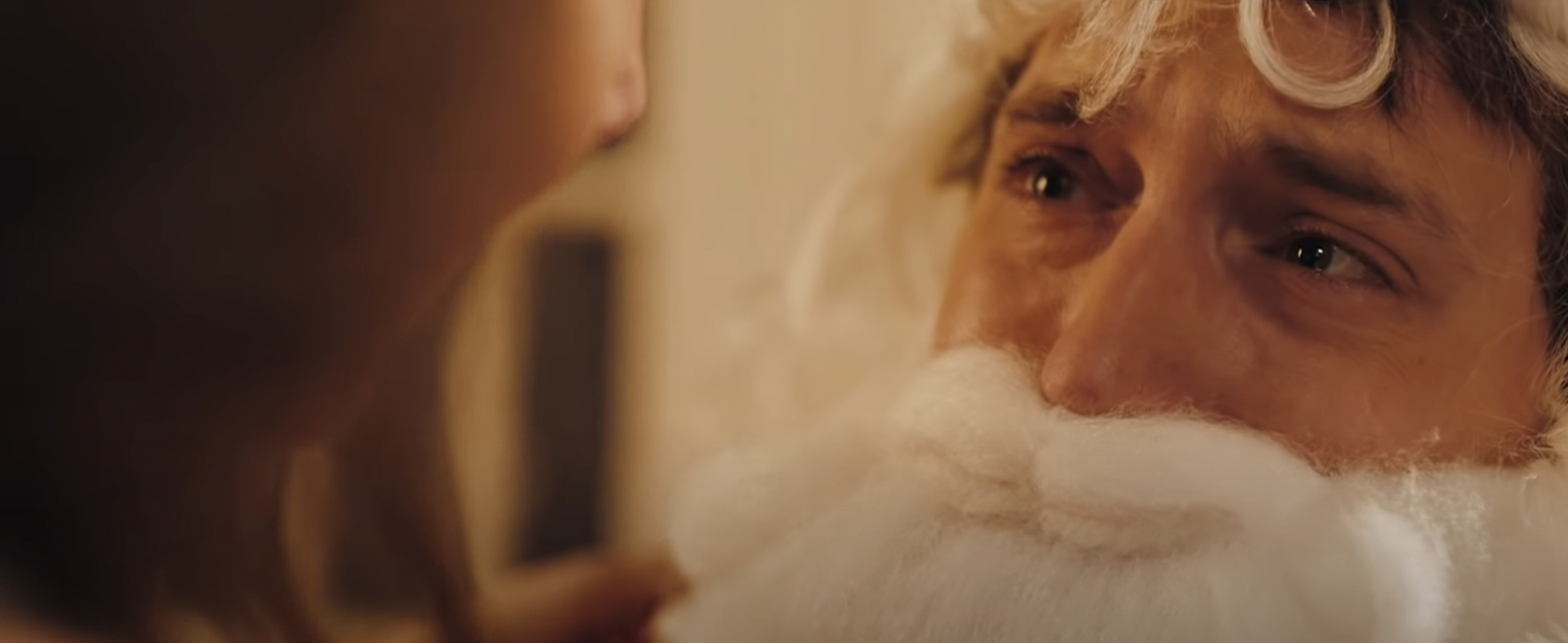a man dressed as Santa cries in fear