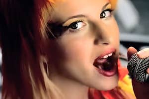 Hayley Williams singing in Paramore's Misery Business music video