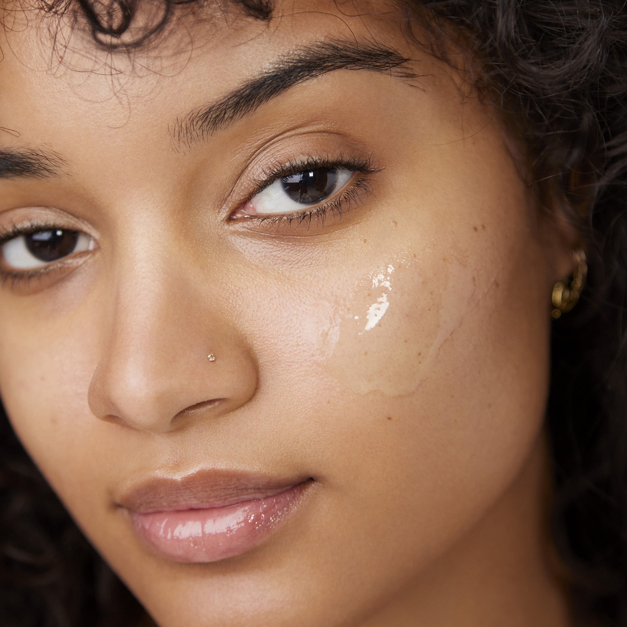 model wearing the primer on their cheek