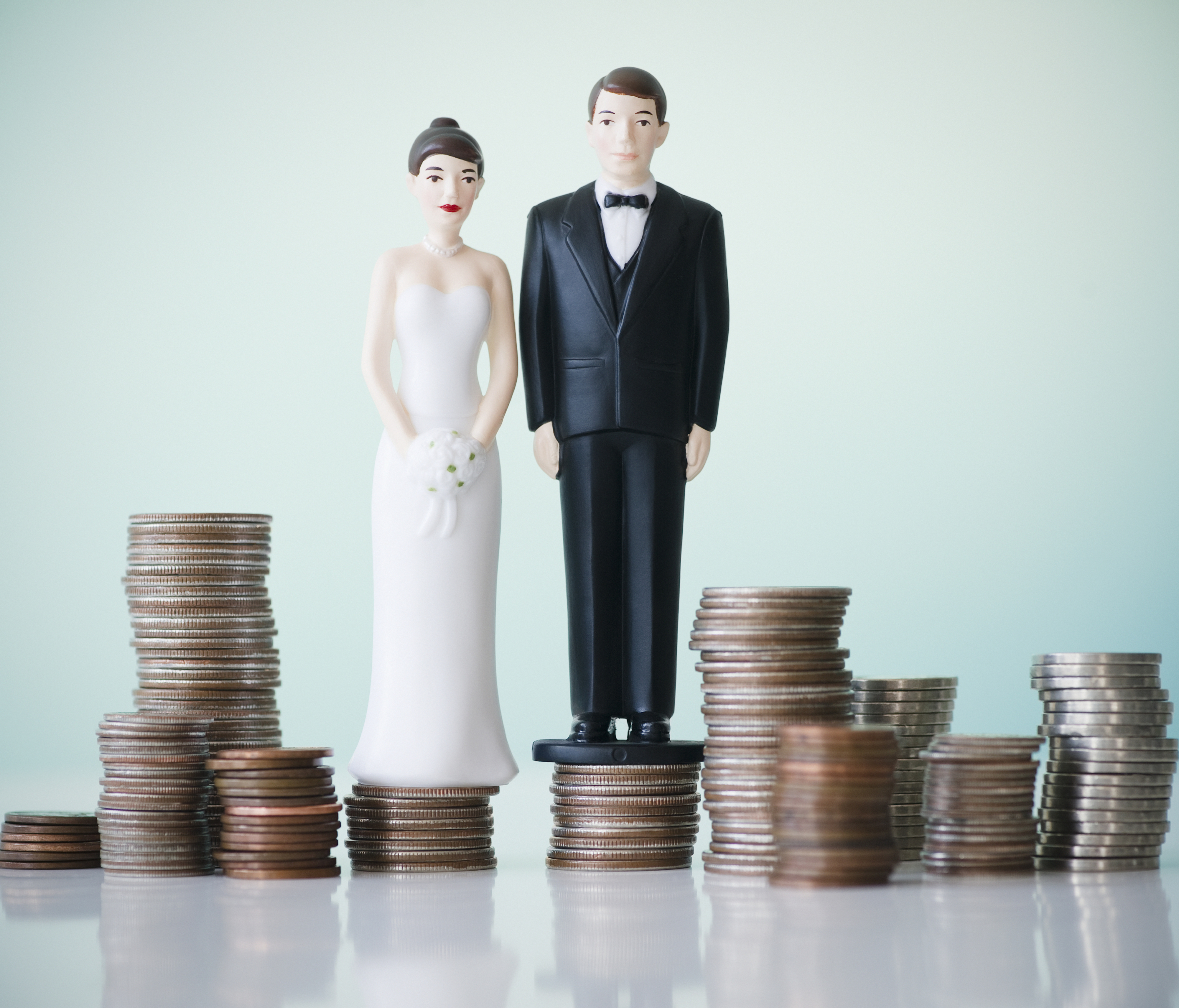 wedding toppers sitting on stacks of quarters
