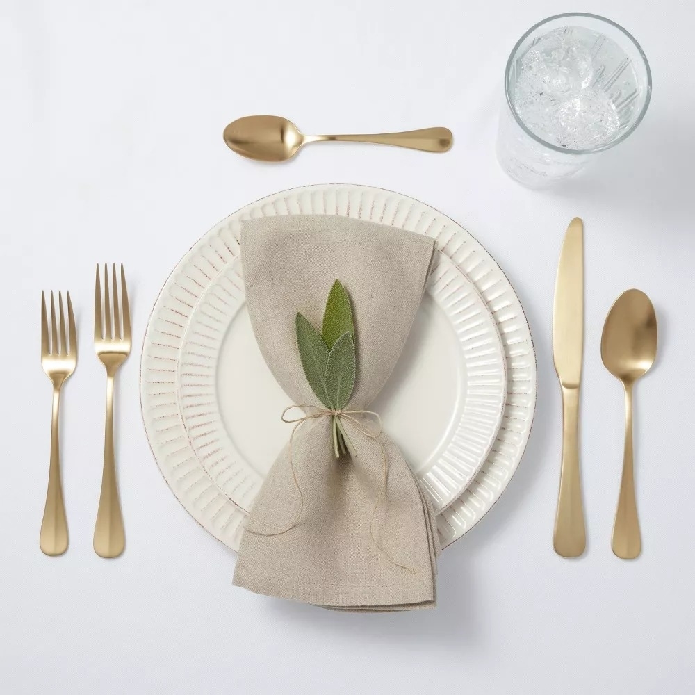 the gold cutlery at a place setting