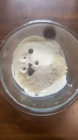 A gif of chocolate chips being sprinkled in a bowl