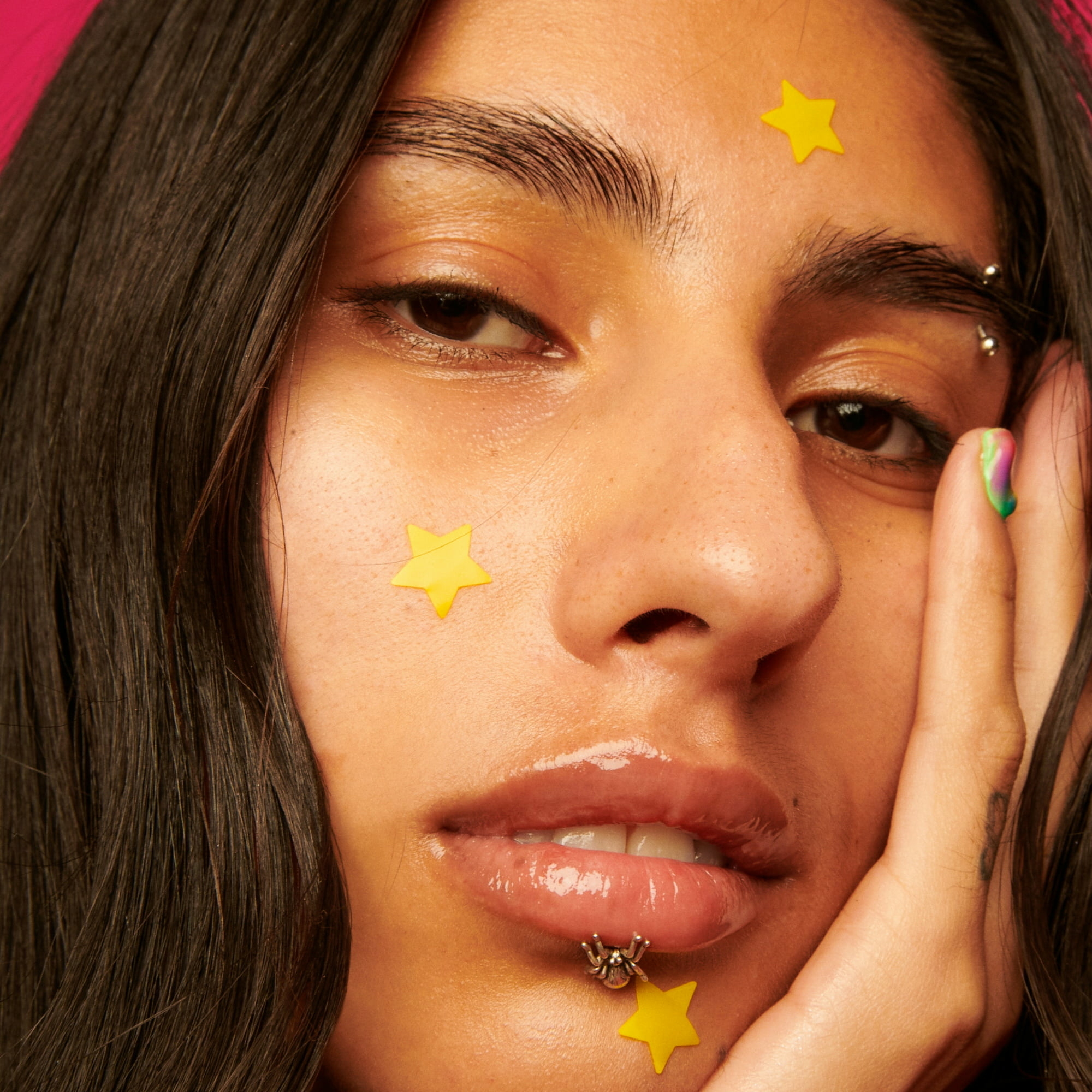A model using the  yellow, star-shaped patches on her face