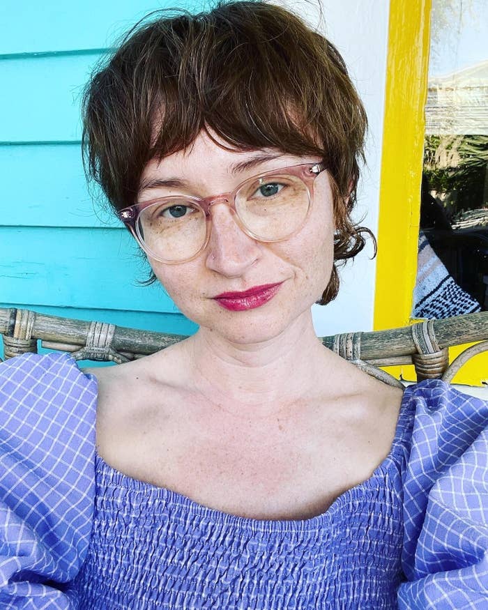 selfie of the author wearing glasses and a purple dress