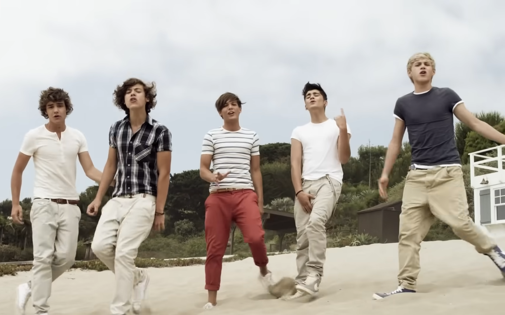 One Direction singing on the beach