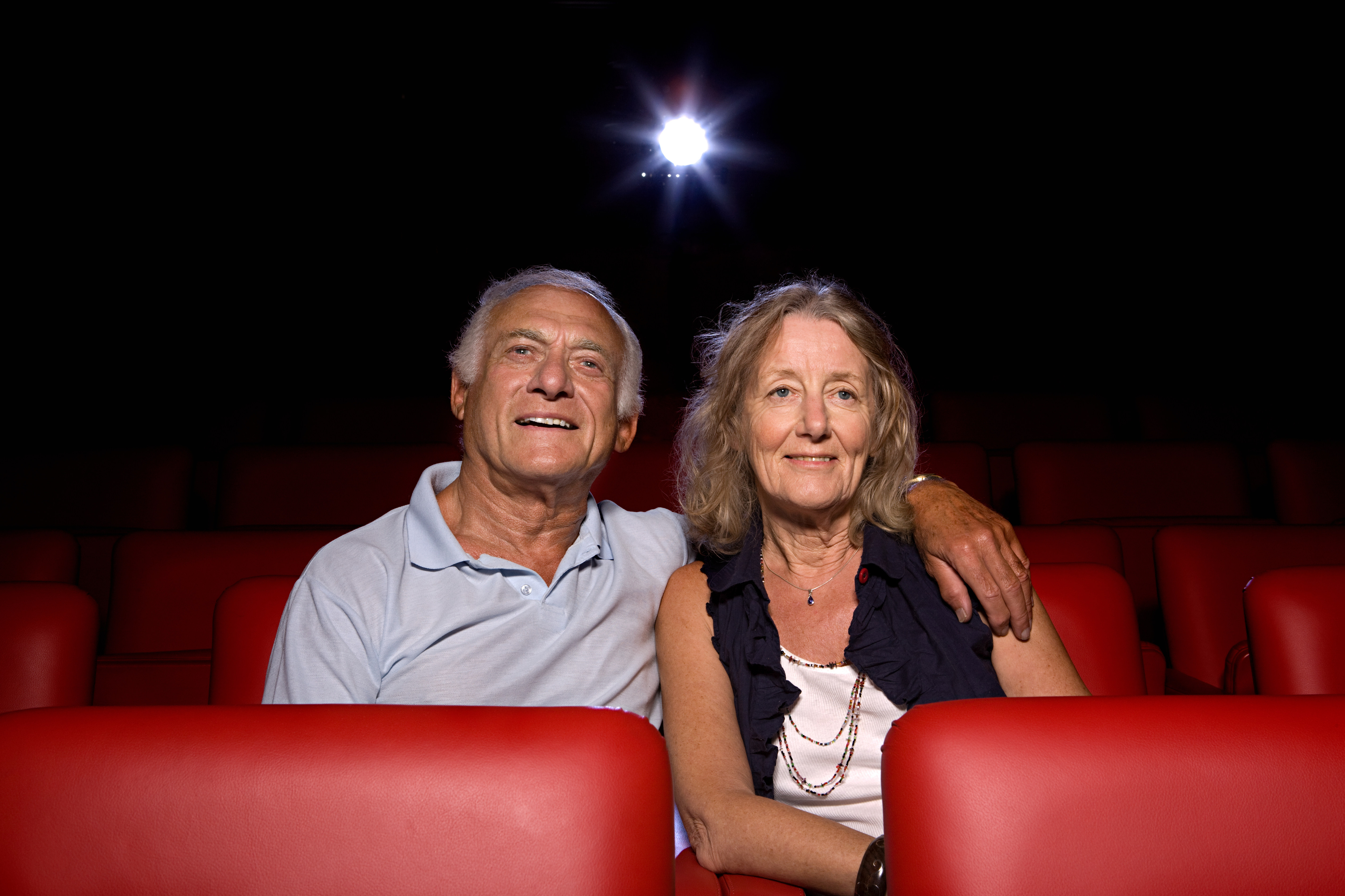 An older couple in a movie theater