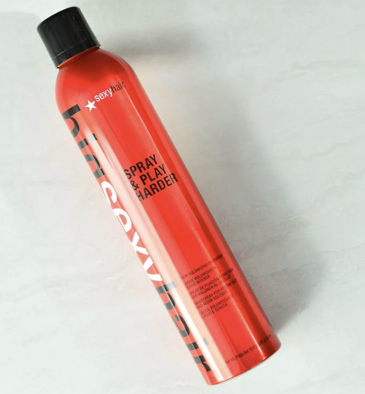 red hairspray bottle